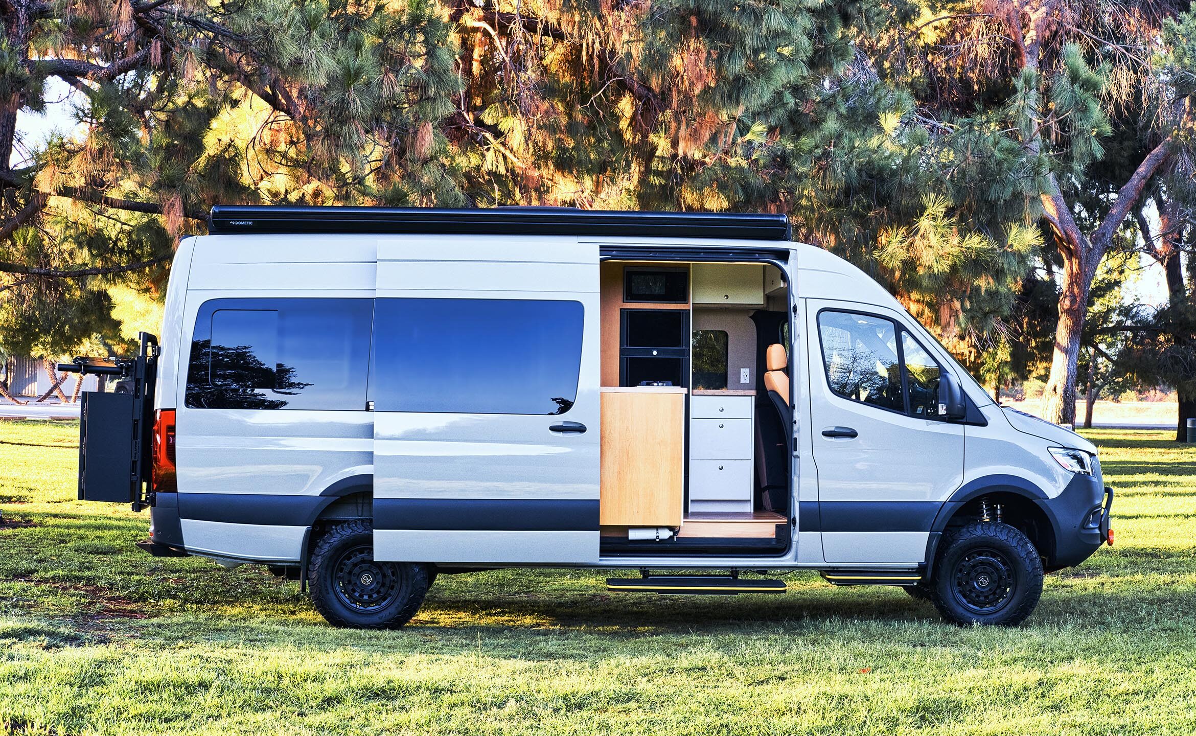 Hero — finished Sprinter camper van, exterior at golden hour